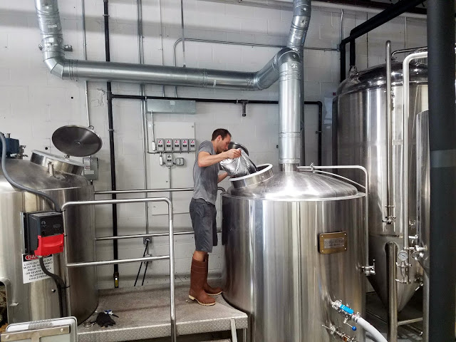 Scott adding Centennial hops to the whirlpool